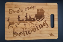 Load image into Gallery viewer, Don&#39;t stop believing santa bamboo cutting board
